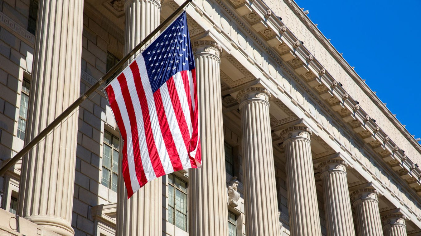 American flag hanging in front of American government building.